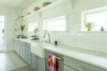 a clean white kitchen with large country style sink