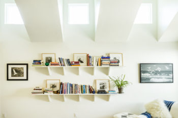 sky lights reflecting on a white wall and white bookshelves